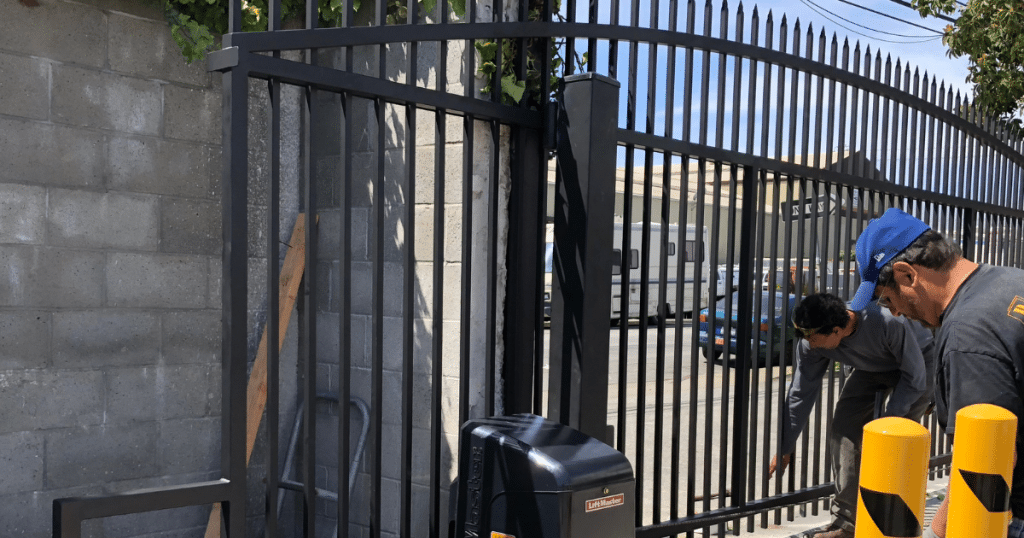 Workers inspecting a metal gate installation.