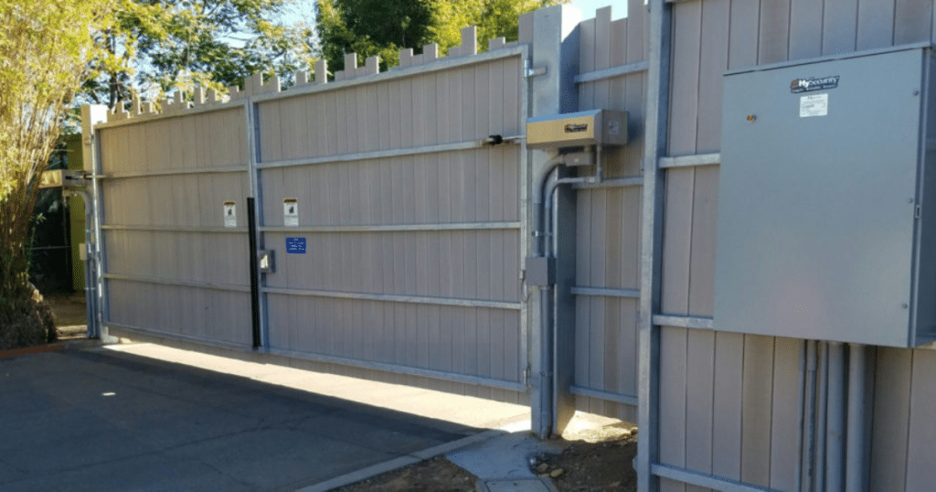 Automated sliding gate with control panels.