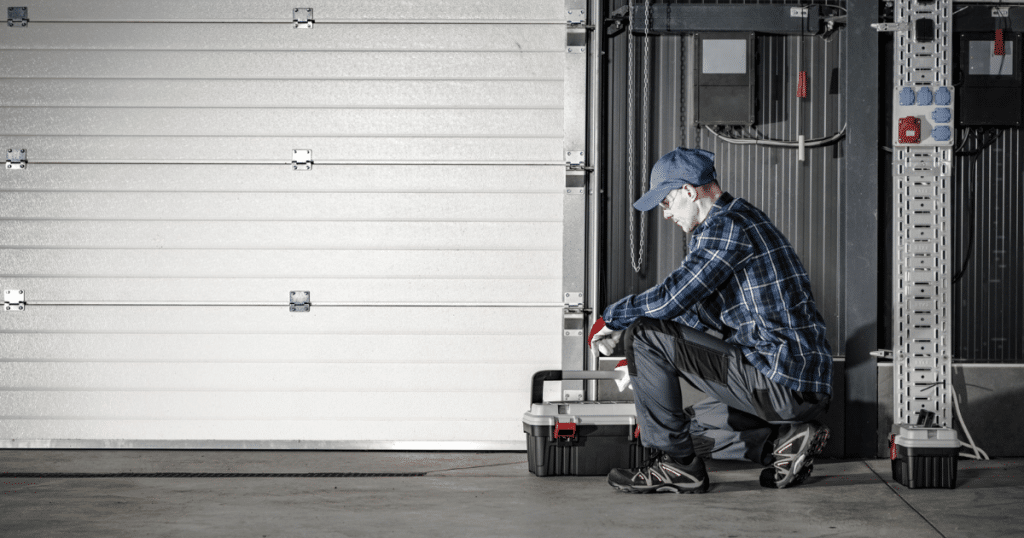 "Technician working near a garage door."