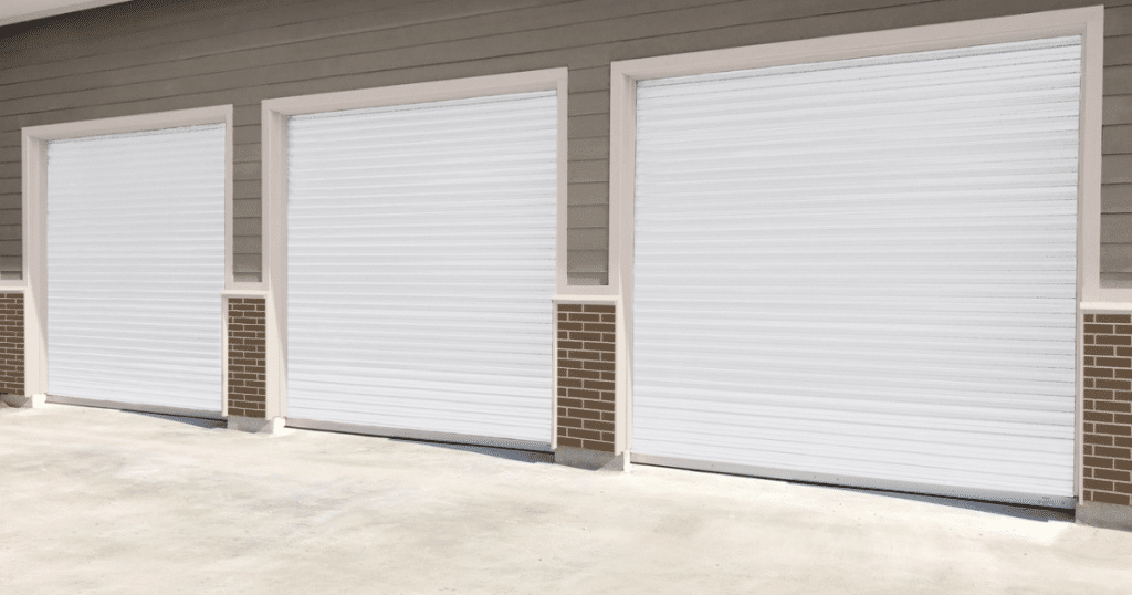 Three closed white rolling garage doors