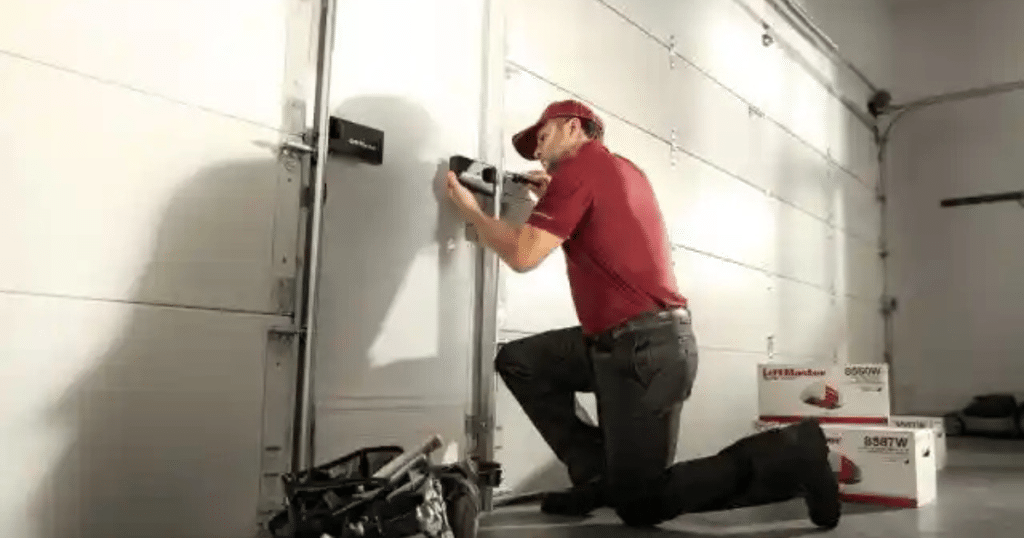 A technician installs a garage door lock.