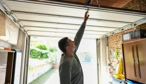 person reaching for garage door